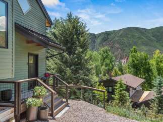 Nestled amidst lush greenery and rolling hills, this property offers a serene mountain retreat.
