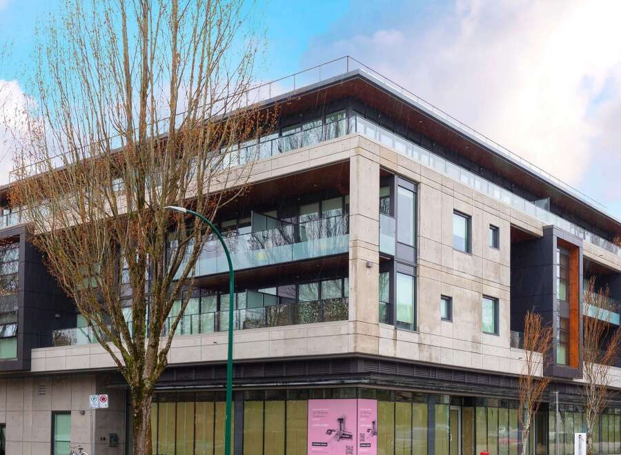 Discover modern living in this stunning multi-story building featuring a sleek concrete facade and expansive glass balconies.