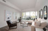 Experience modern living in this bright and airy living room, featuring a comfortable sectional sofa and a stylish accent chair.