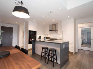 Experience modern living in this stunning condo featuring a sleek, contemporary kitchen with a spacious island and high-end appliances.