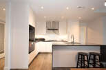 Experience modern living in this sleek kitchen featuring high-end stainless steel appliances, including a built-in microwave and oven.