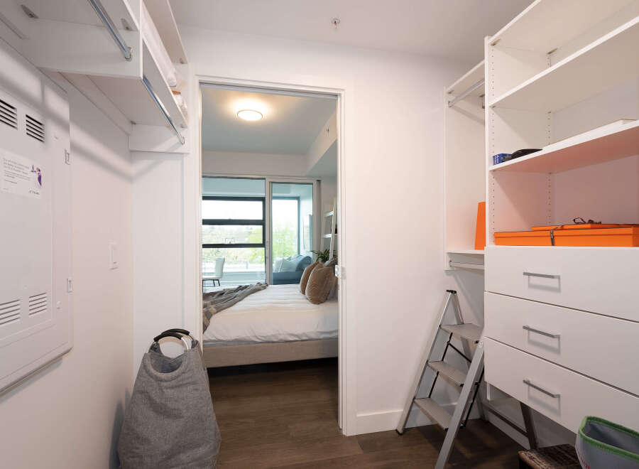 Step into this spacious walk-in closet, featuring ample shelving and drawers for all your storage needs.