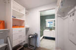 Step into this spacious walk-in closet, featuring ample shelving and drawers for organized storage.