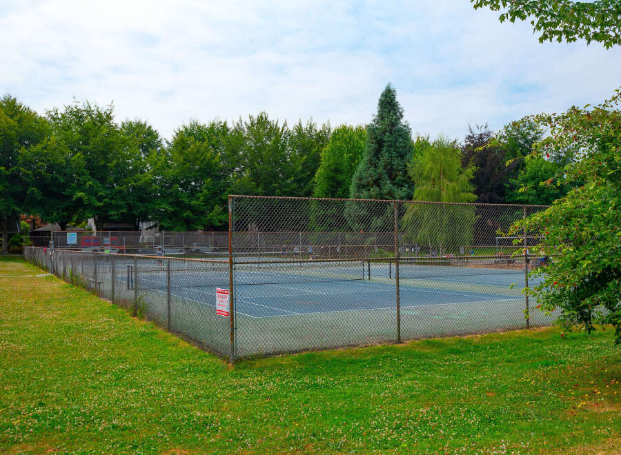 Enjoy outdoor recreation at this property featuring a well-maintained tennis court, perfect for a friendly match or practice.