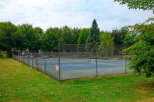 Enjoy outdoor recreation at this property featuring a well-maintained tennis court, perfect for a friendly match or practice.