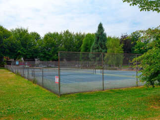 Enjoy outdoor recreation at this property featuring a well-maintained tennis court, perfect for a friendly match or practice.