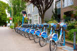 Discover convenient urban living with this prime real estate opportunity, featuring a row of readily available bike rentals perfect for exploring the vibrant neighborhood.