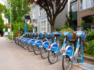 Discover convenient urban living with this prime real estate opportunity, featuring a row of readily available bike rentals perfect for exploring the vibrant neighborhood.