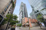 Experience modern urban living in this stunning high-rise building, featuring sleek architecture and expansive balconies.