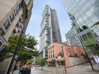 Experience modern urban living in this stunning high-rise building, featuring sleek architecture and expansive balconies.