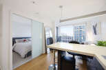 Experience modern urban living in this stylish studio apartment, featuring a sleek open-concept layout with a dedicated sleeping area separated by elegant sliding doors.