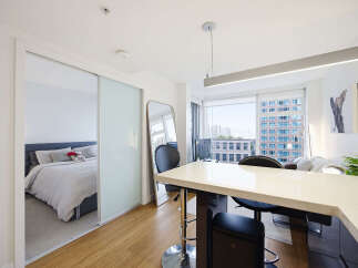 Experience modern urban living in this stylish studio apartment, featuring a sleek open-concept layout with a dedicated sleeping area separated by elegant sliding doors.