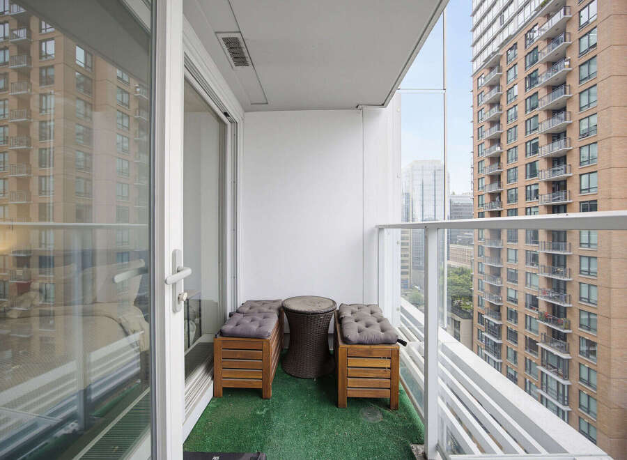 Enjoy your morning coffee or evening relaxation on this charming balcony, complete with comfortable seating and a stylish side table.