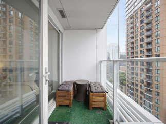 Enjoy your morning coffee or evening relaxation on this charming balcony, complete with comfortable seating and a stylish side table.
