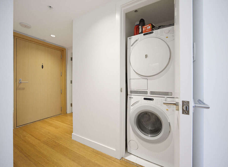 Discover modern convenience with this stacked Miele washer and dryer unit, perfect for maximizing space in your home.