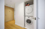 Discover modern convenience with this stacked Miele washer and dryer unit, perfect for maximizing space in your home.