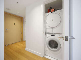 Discover modern convenience with this stacked Miele washer and dryer unit, perfect for maximizing space in your home.