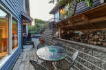 Enjoy outdoor living in this charming backyard featuring a mosaic dining set perfect for al fresco meals.