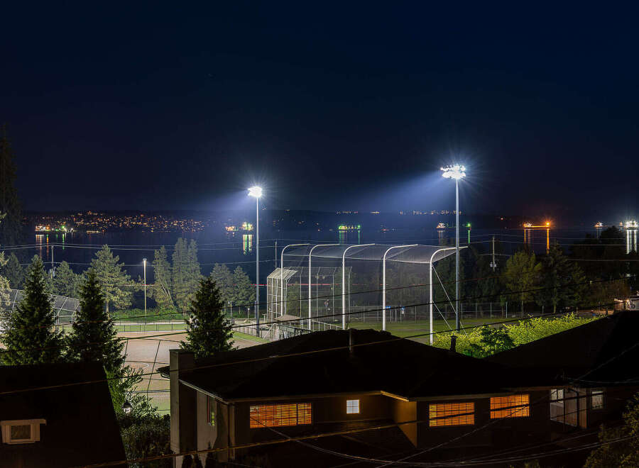 Experience the best of both worlds with this stunning property offering breathtaking nighttime views of a vibrant city skyline and a serene waterfront.
