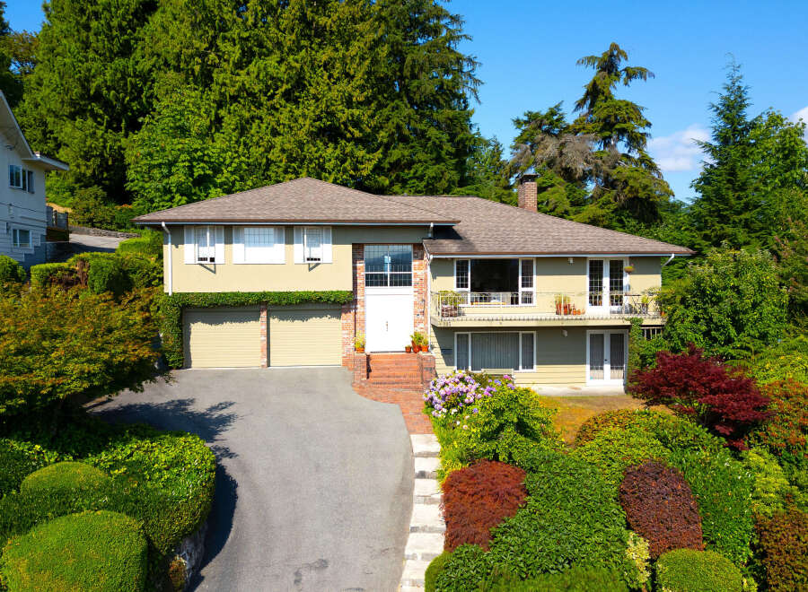 Discover this charming home nestled amidst lush greenery and mature trees, offering a serene and private retreat.