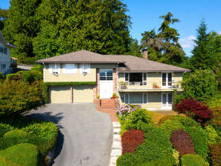 Discover this charming home nestled amidst lush greenery and mature trees, offering a serene and private retreat.