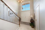 Step into this grand foyer featuring a soaring ceiling and a stunning Palladian window that floods the space with natural light.