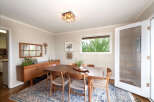 This dining room features a beautiful wooden dining table with four chairs, perfect for intimate gatherings.