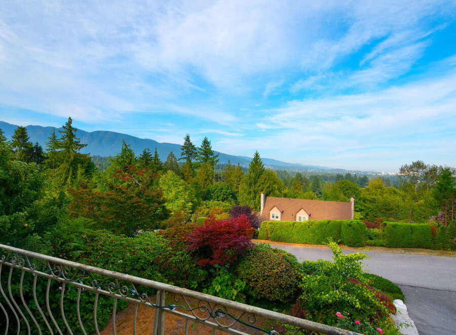 Experience breathtaking mountain views from this stunning property, nestled amidst lush greenery and vibrant foliage.