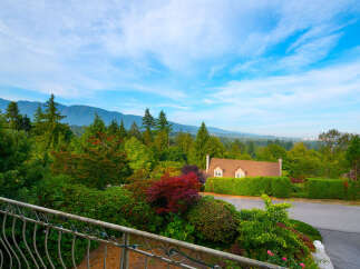 Experience breathtaking mountain views from this stunning property, nestled amidst lush greenery and vibrant foliage.