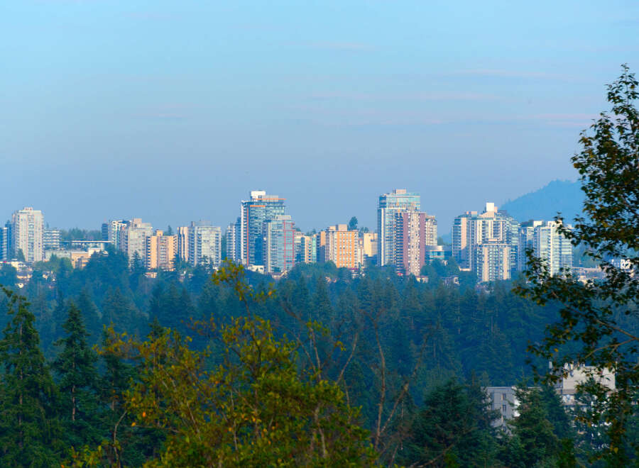 Discover modern living amidst nature with this stunning cityscape view.