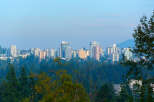 Discover modern living amidst nature with this stunning cityscape view.