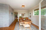 This dining room features a beautiful wooden dining table with four chairs, set on an ornate rug.
