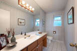 This charming bathroom features a spacious vanity with a double sink and ample counter space, perfect for morning routines.
