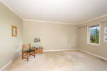 This spacious room features a large window offering picturesque views of lush greenery and mountains.
