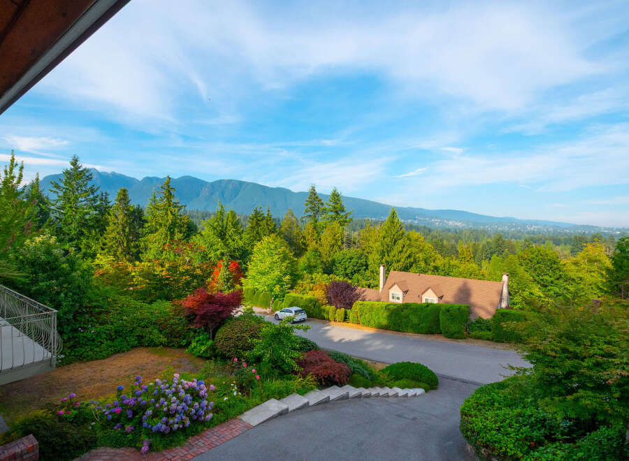 Experience breathtaking mountain views from this stunning property, nestled amidst lush greenery and vibrant gardens.