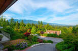 Experience breathtaking mountain views from this stunning property, nestled amidst lush greenery and vibrant gardens.