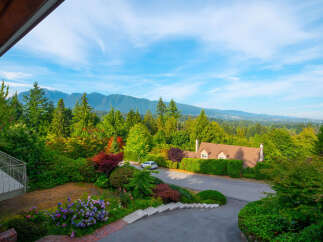 Experience breathtaking mountain views from this stunning property, nestled amidst lush greenery and vibrant gardens.