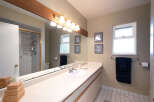 This bathroom features a spacious vanity with a double sink and ample counter space, perfect for busy mornings.