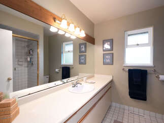 This bathroom features a spacious vanity with a double sink and ample counter space, perfect for busy mornings.