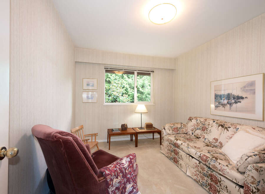 This cozy living room features a floral-patterned sofa and a plush armchair, perfect for relaxation.