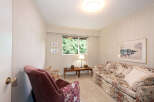 This cozy living room features a floral-patterned sofa and a plush armchair, perfect for relaxation.