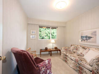 This cozy living room features a floral-patterned sofa and a plush armchair, perfect for relaxation.
