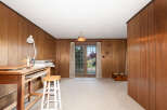 Discover a versatile space with warm wood paneling and a bright, airy feel, perfect for an art studio or creative retreat.