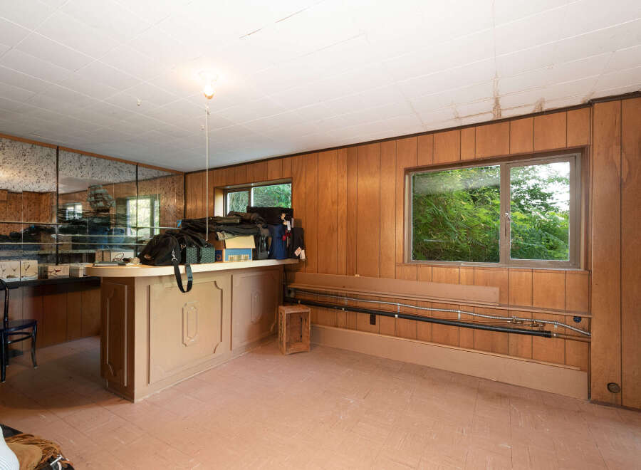 This room features a built-in bar area with mirrored walls, perfect for entertaining.