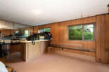 This room features a built-in bar area with mirrored walls, perfect for entertaining.