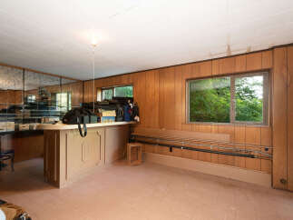 This room features a built-in bar area with mirrored walls, perfect for entertaining.