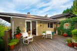 Enjoy outdoor living on this spacious wooden deck, perfect for entertaining or relaxing.