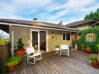 Enjoy outdoor living on this spacious wooden deck, perfect for entertaining or relaxing.