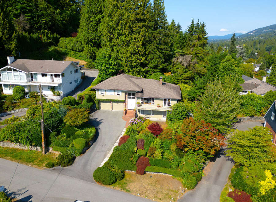 Discover this charming home nestled amidst lush greenery and mature trees, offering a serene and private retreat.