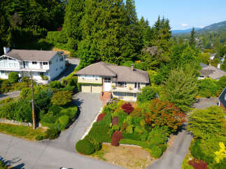 Discover this charming home nestled amidst lush greenery and mature trees, offering a serene and private retreat.